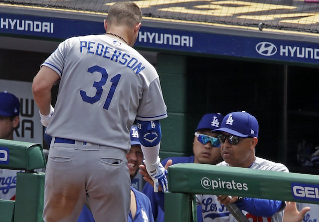 Los Angeles Dodgers manager Dave Roberts greets Joc Pederson in the dugout at PNC Park