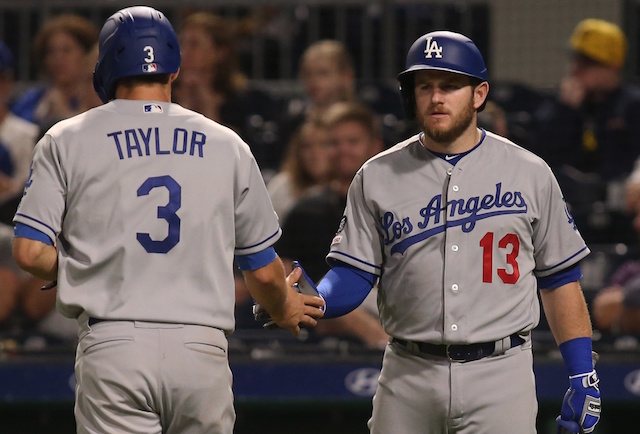 Los Angles Dodgers teammates Max Muncy and Chris Taylor celebrate during a game against the Pittsburgh Pirates