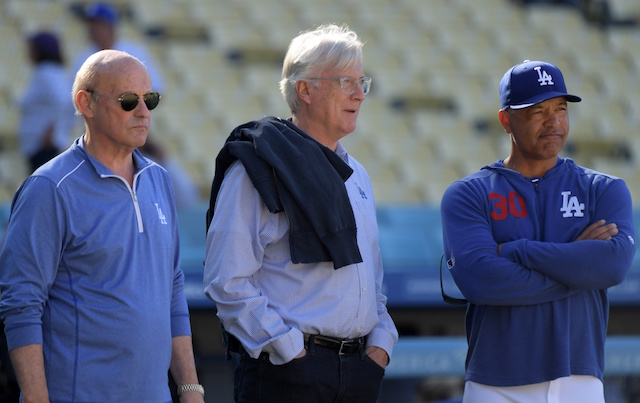 Los Angeles Dodgers president and CEO Stan Kasten, manager Dave Roberts and owner Mark Walter watch batting practice at Dodger Stadium