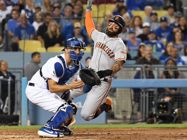 Los Angeles Dodgers catcher Austin Barnes waits for a throw at home plate