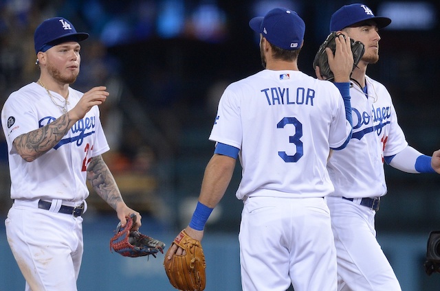 Cody Bellinger, Chris Taylor and Alex Verdugo celebrate after a Los Angeles Dodgers win at Dodger Stadium