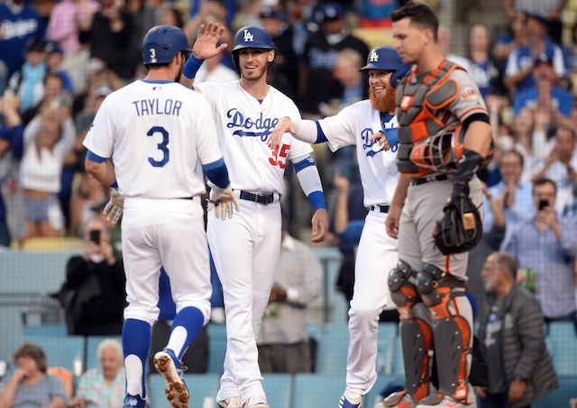 Cody Bellinger and Justin Turner congratulate Chris Taylor after his home run gives the Los Angeles Dodgers a lead against the San Francisco Giants