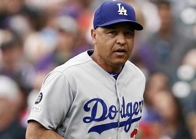 Los Angeles Dodgers manager Dave Roberts runs onto the field for a pitching change against the Colorado Rockies