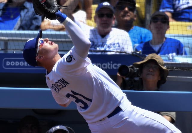 Los Angeles Dodgers first baseman Joc Pederson makes a catch in foul territory