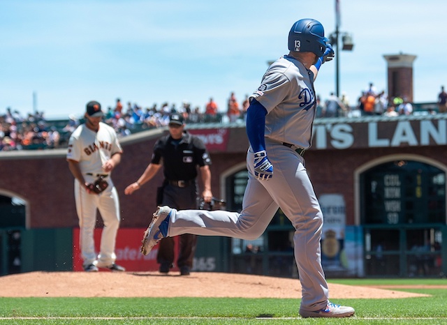 Los Angeles Dodgers infielder Max Muncy gestures after hitting a home run against San Francisco Giants starting pitcher Madison Bumgarner