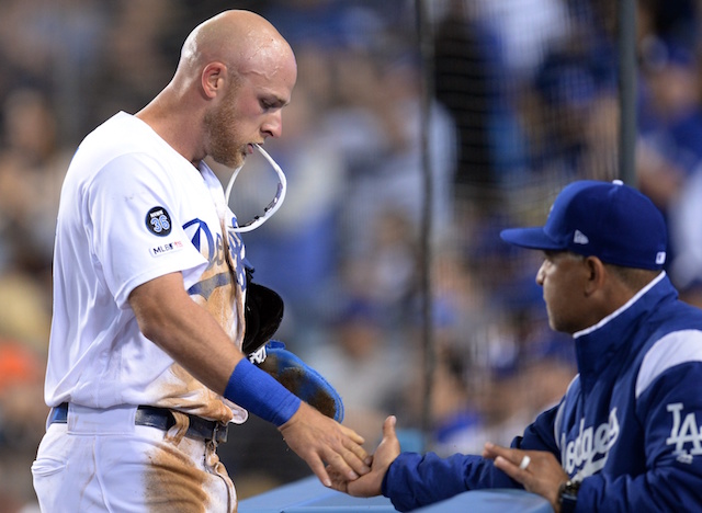 Matt Beaty is congratulated by Los Angeles Dodgers manager Dave Roberts after scoring