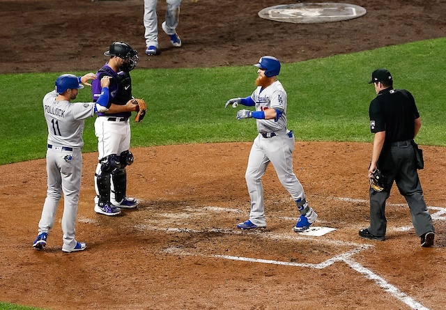 Los Angeles Dodgers teammates A.J. Pollock and Justin Turner celebrate after a home run against the Colorado Rockies