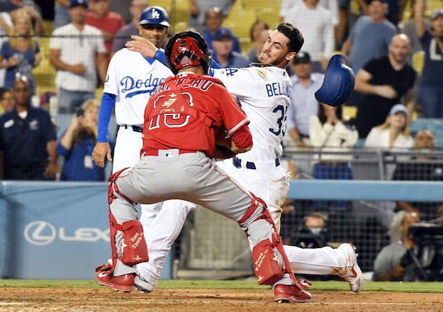 Los Angeles Dodgers third base coach Dino Ebel watches Cody Bellinger on his attempt to score against the Los Angeles Angels of Anaheim