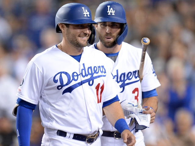 Los Angeles Dodgers teammates A.J. Pollock and Chris Taylor react