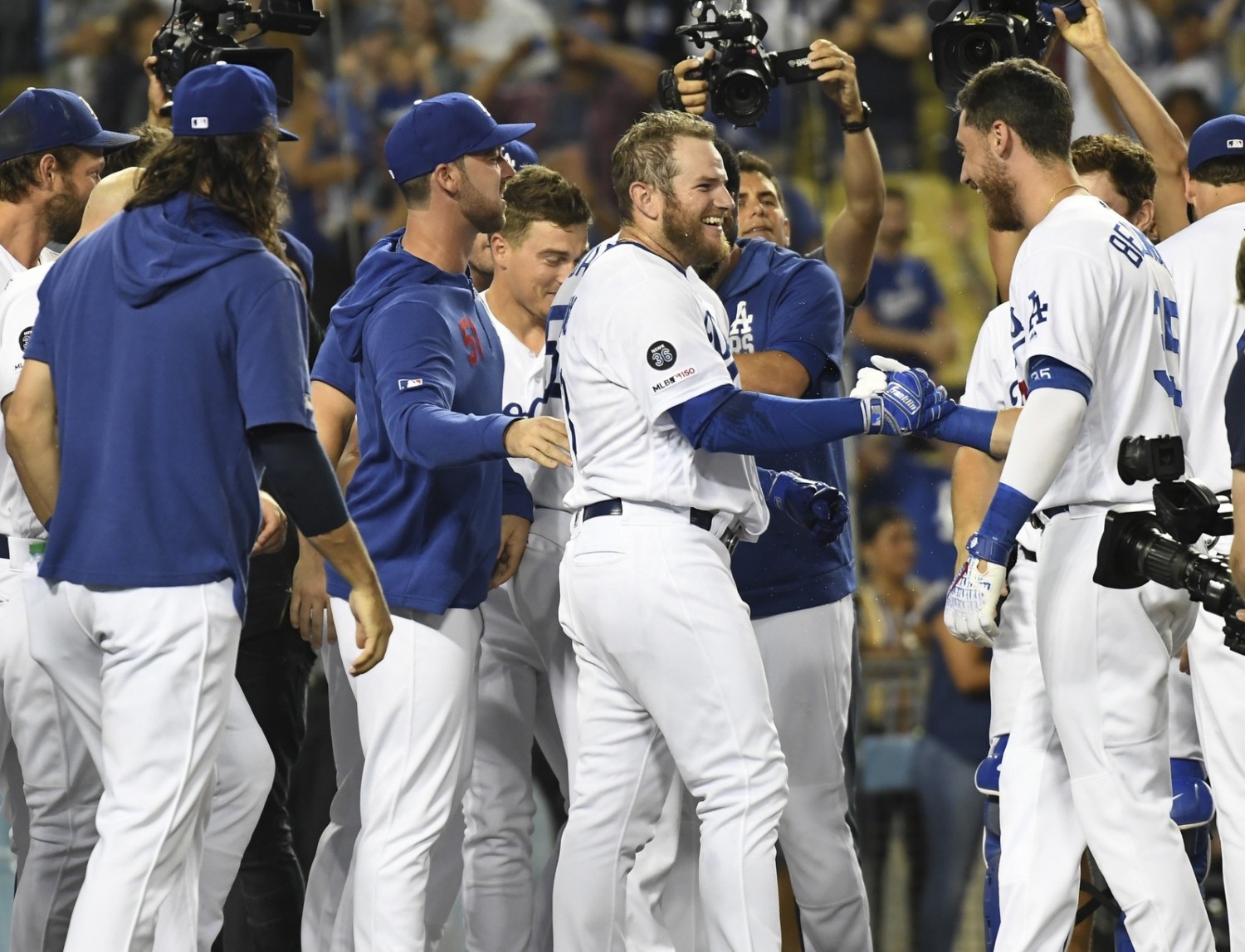 Los Angeles Dodgers teammates Cody Bellinger, Dylan Floro, Kiké Hernandez, Clayton Kershaw and Max Muncy celebrate after a walk-off win