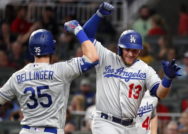 Los Angeles Dodgers teammates Cody Bellinger and Max Muncy celebrate after hitting a home run