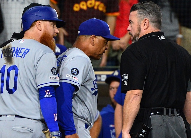 Los Angeles Dodgers manager Dave Roberts and Justin Turner argue with umpire Rob Drake