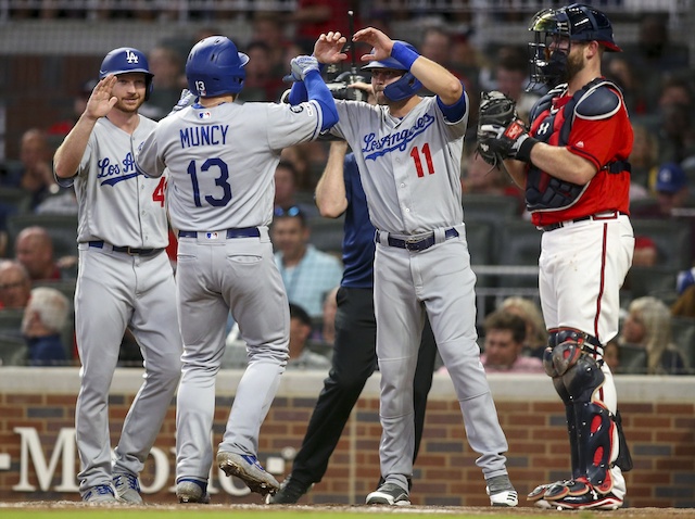 Los Angeles Dodgers teammates Kyle Garlick, Max Muncy and A.J. Pollock celebrate after a home run