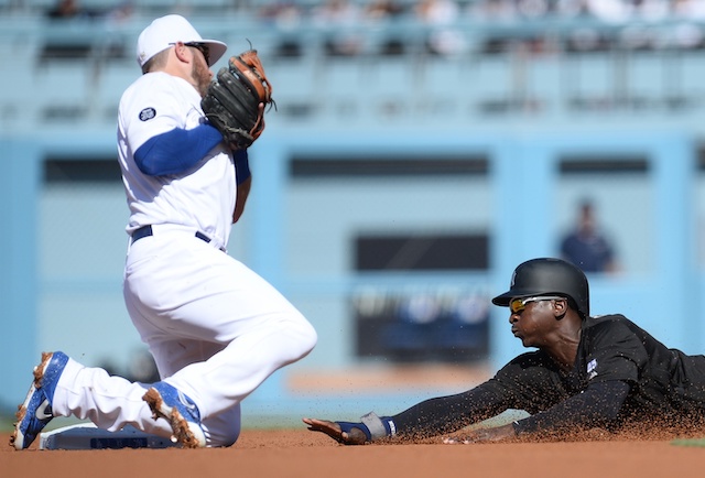 Los Angeles Dodgers infielder Max Muncy receives a throw on a stolen base attempt