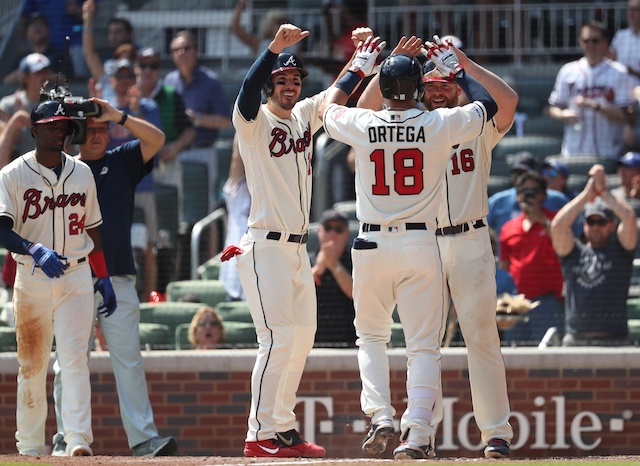 Atlanta Braves teammates celebrate after Rafael Ortega's grand slam against the Los Angeles Dodgers