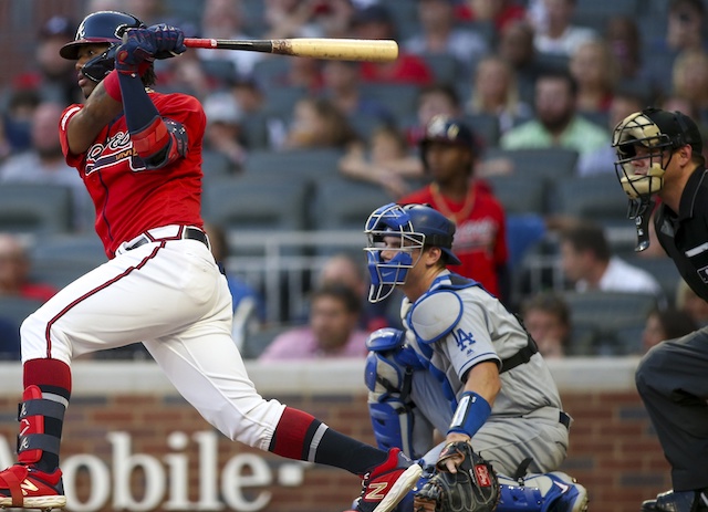 Los Angeles Dodgers catcher Will Smith looks on as Ronald Acuña Jr. hits an RBI single