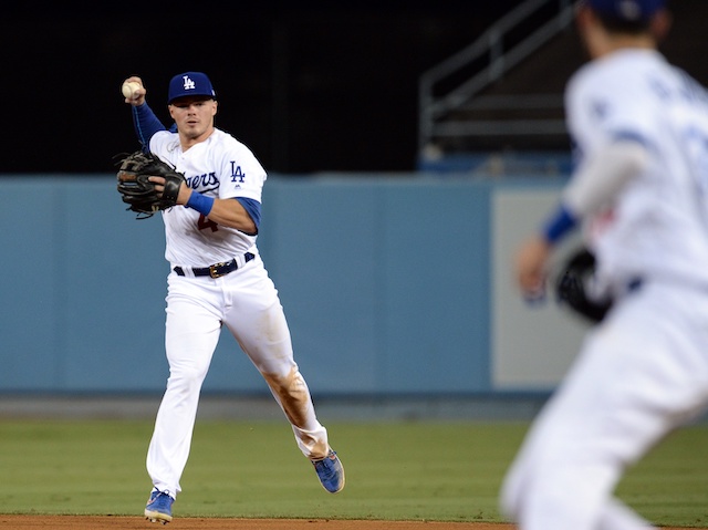 Los Angeles Dodgers infielder Gavin Lux throws the ball to Cody Bellinger