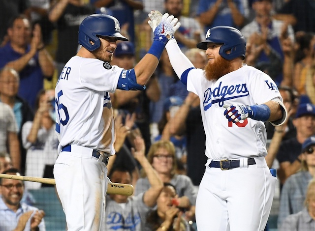 Los Angeles Dodgers teammates Cody Bellinger and Justin Turner celebrate after a home run