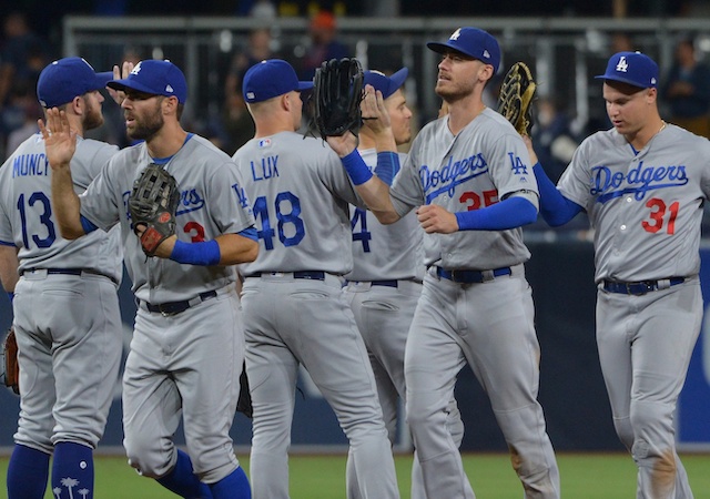 Los Angeles Dodgers teammates Cody Bellinger, Kiké Hernandez, Gavin Lux, Max Muncy, Joc Pederson and Chris Taylor celebrate after a win against the San Diego Padres