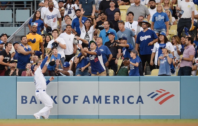 Los Angeles Dodgers outfielder Joc Pederson robs Charlie Blackmon of a home run before crashing into the wall at Dodger Stadium