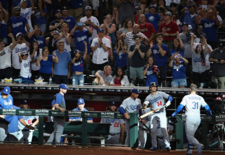 Los Angeles Dodgers manager Dave Roberts and Kiké Hernandez celebrate with Joc Pederson after a home run