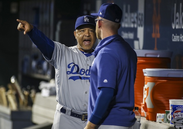 Los Angeles Dodgers manager Dave Roberts speaks with Matt Beaty in the dugout