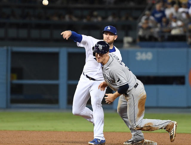 Los Angeles Dodgers infielder Max Muncy throws to first base