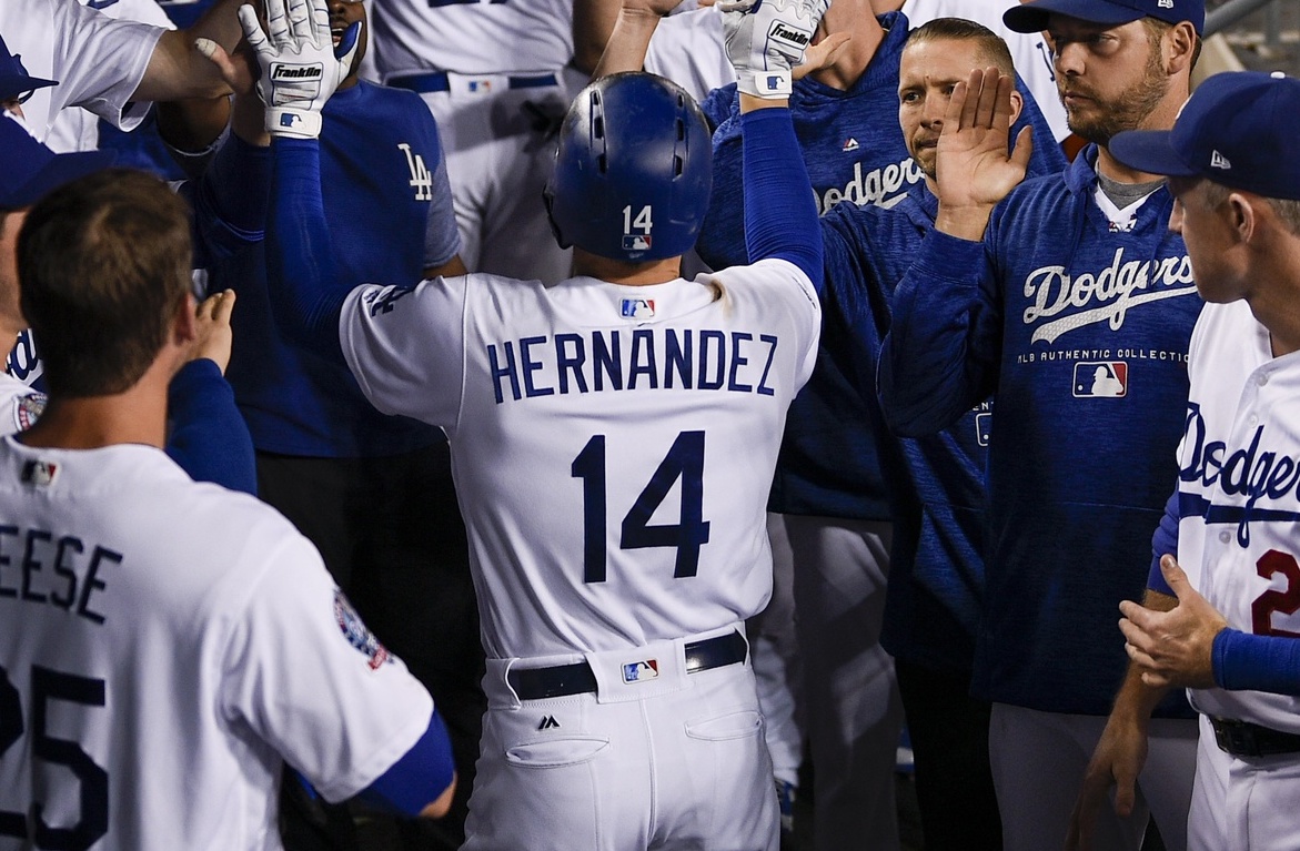 Los Angeles Dodgers teammates David Freese, Kiké Hernandez, Rich Hill and Chase Utley celebrate in the dugout