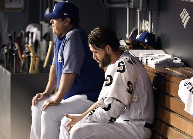 Los Angeles Dodgers pitching coach Rick Honeycutt with Clayton Kershaw in the dugout during Game 2 of the 2019 NLDS