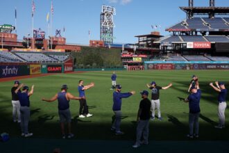 Alex Vesia, Clayton Kershaw, Tanner Scott, Kirby Yates, Jack Dreyer, trainer Eric Yavarone, Dodgers pitchers stretching, 2025 NLDS